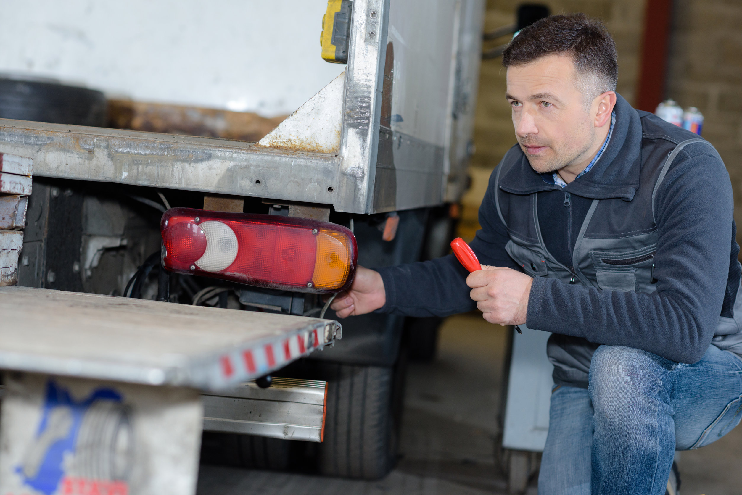 Auto Mechanic Repairing Truck